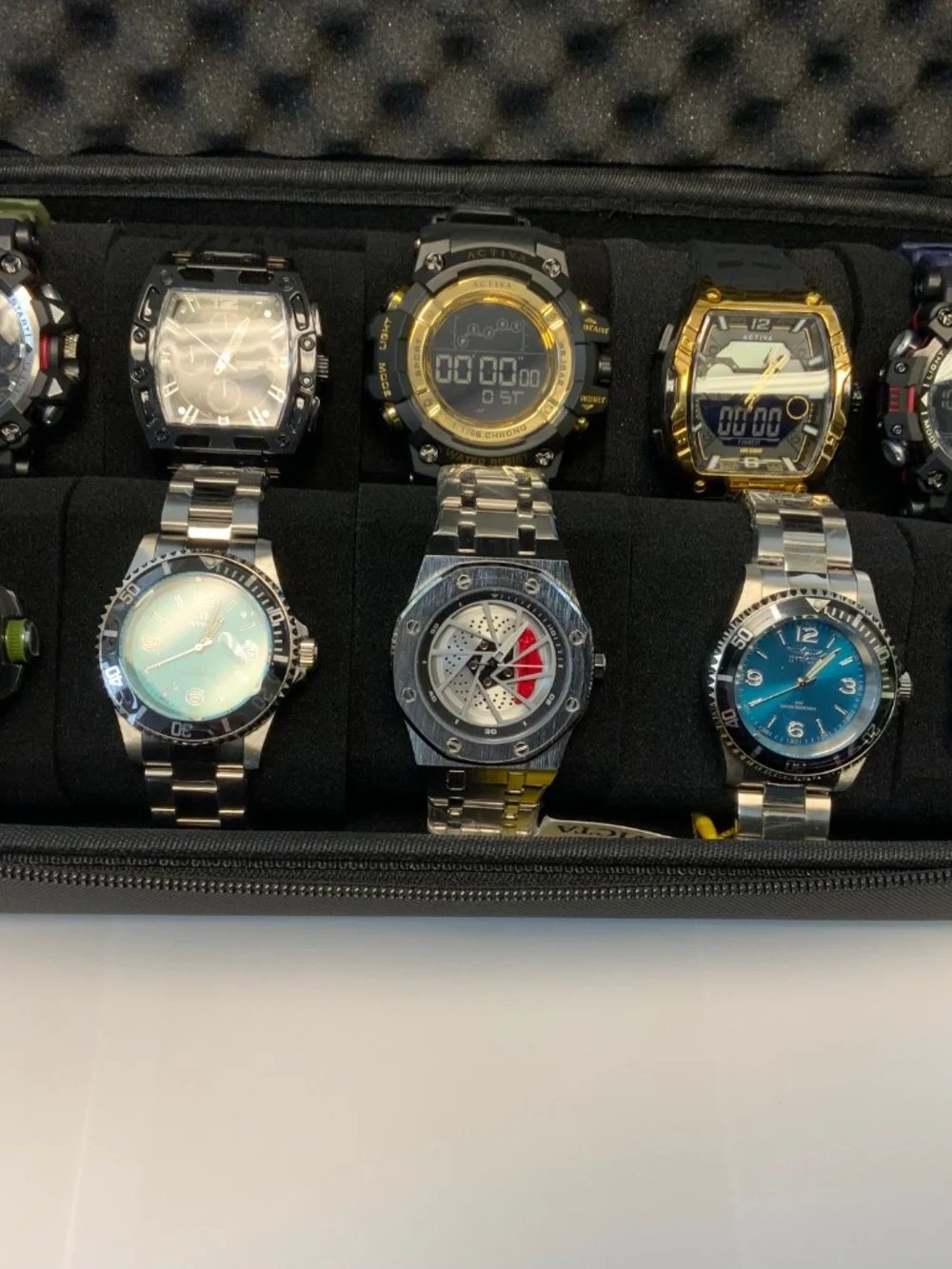 10 INVICTA WATCHES WITH HARD SHELL CASE. ALL NEW AND WITH THE BOXES AND TAGS